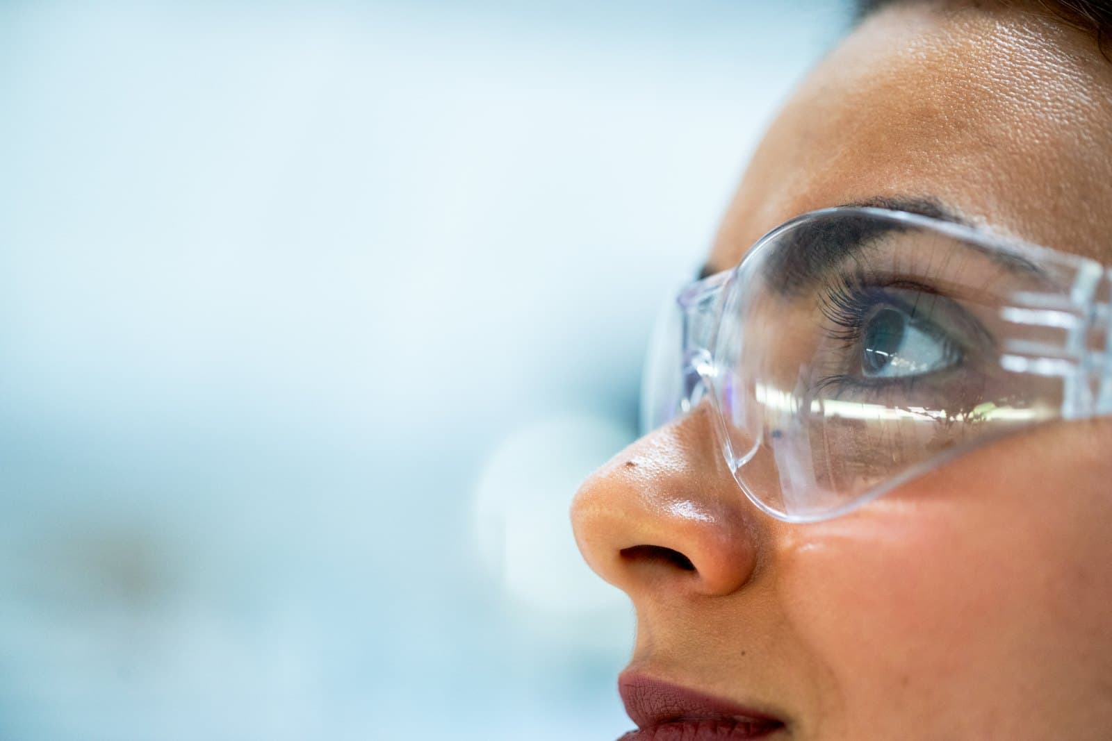 A close inspection under light, eye and protective eyewear in frame.