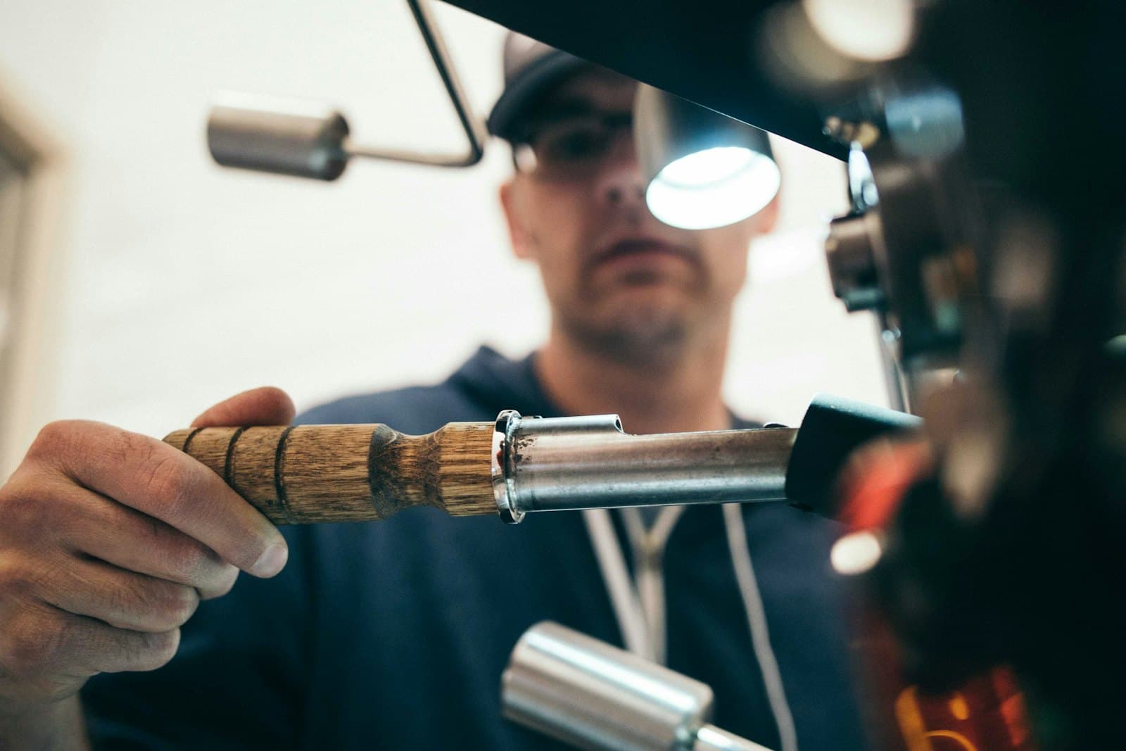 An installer working precisely under focused light.