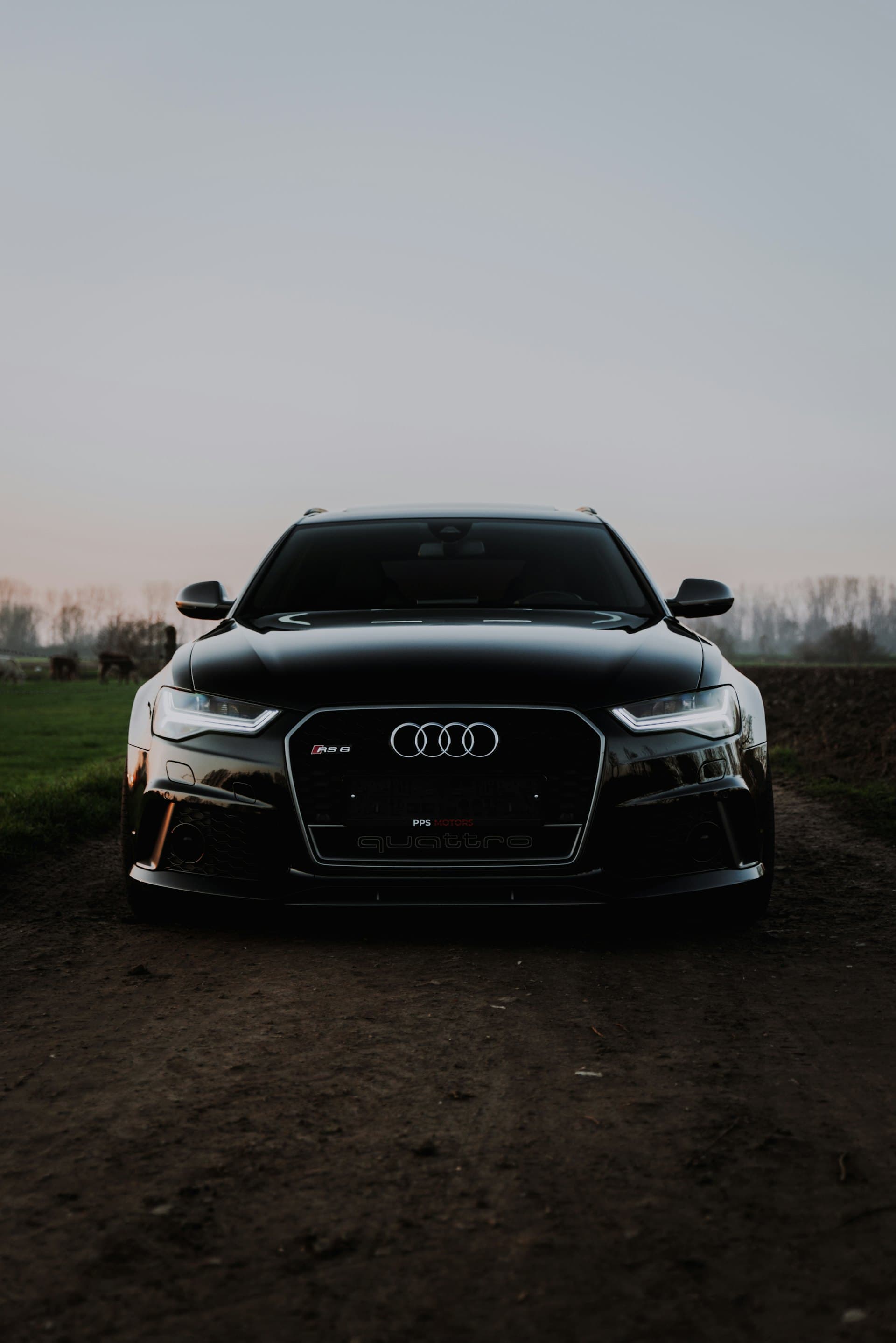 A black performance wagon at twilight with ceramic-tinted glass.